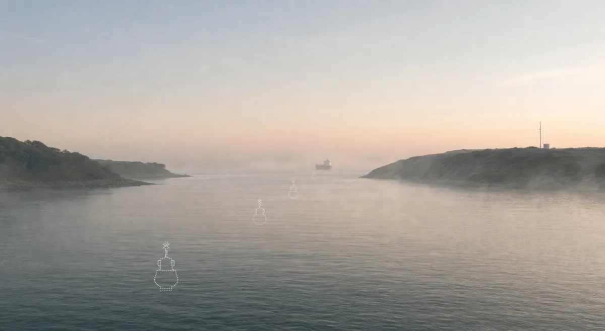 Virtual Buoys marks a misty empty fairway as a distant vessel approaches at dawn.