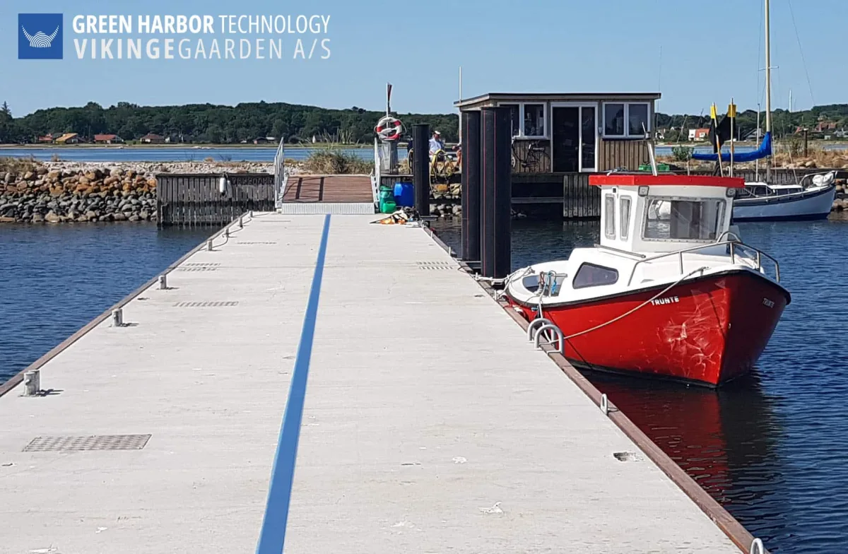 Concrete floating bridge at Nykøbing Mors Harbor, with vessels moored alongside.