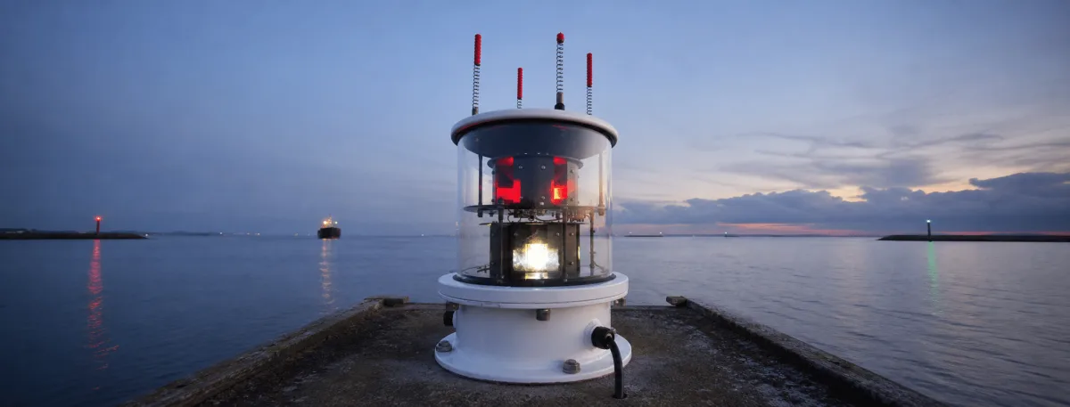 An MBL 400S LED sector light marks the harbor approach with red, white and green sectors at dusk.