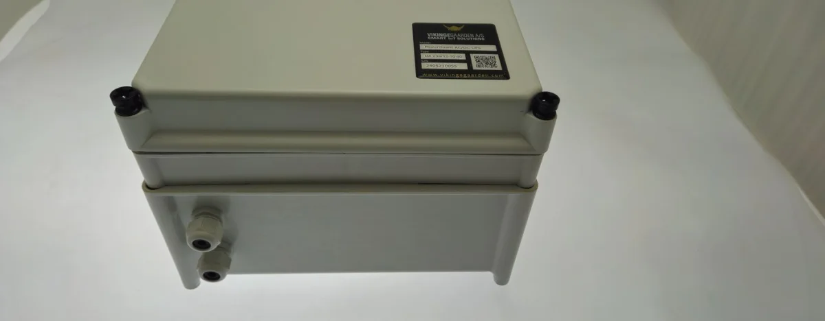 The PowerGuard enclosure on its own: a sealed light grey box with a rating plate and cable glands underneath.