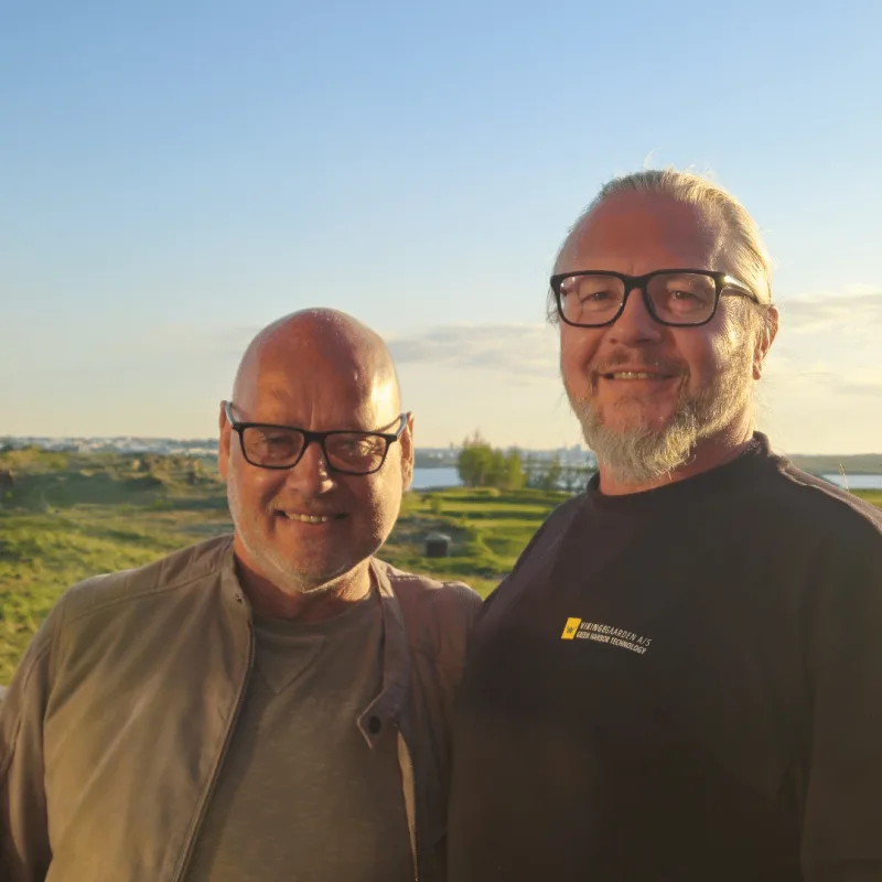 Two men pictured outdoors beside the water in Vikingegaarden's Iceland representative profile.