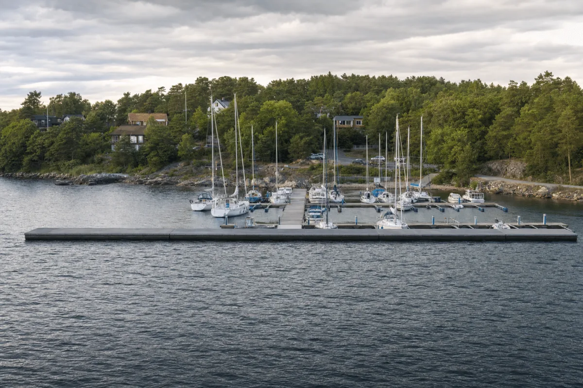 Vikingegaarden floating breakwater protects a complete marina with piers, boat booms and service pedestals.