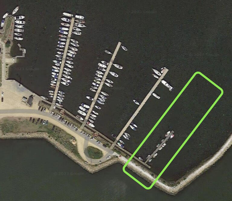 Aerial harbor plan with the proposed floating bridge extension outlined in green.